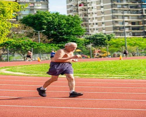 Mature person happily jogging in a public park in Medellin, Colombia